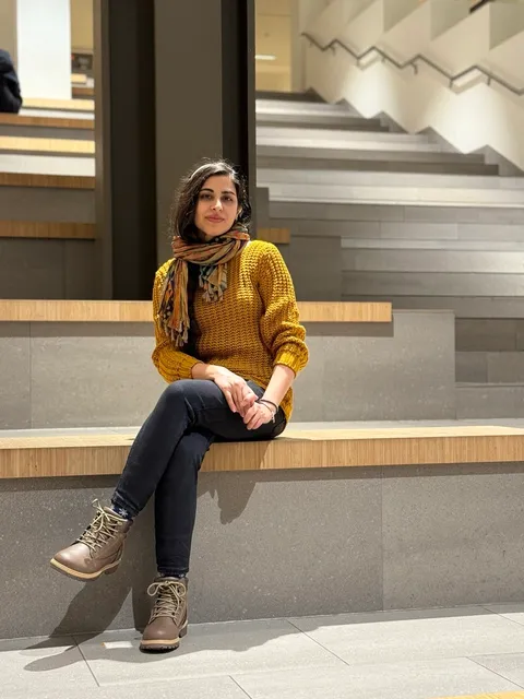 Mahnaz in a modern university building